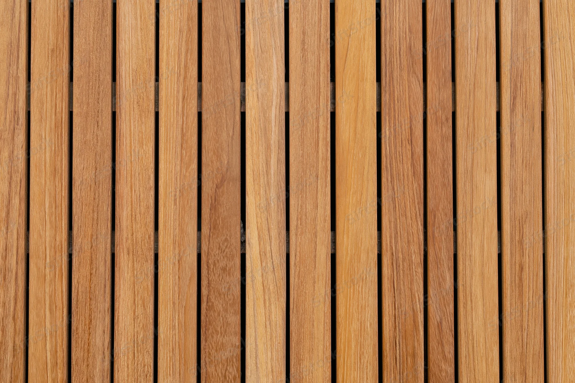 Vertical teak wood planks arranged in a flat lay close-up view