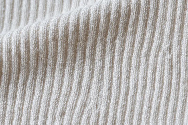 White ribbed cotton knit fabric in flat lay closeup filling frame