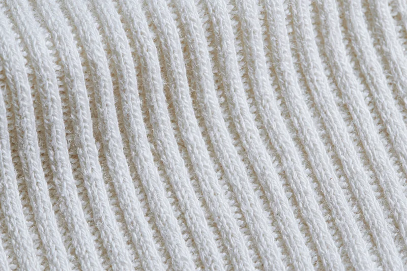 White ribbed cotton knit fabric in flat lay closeup filling frame