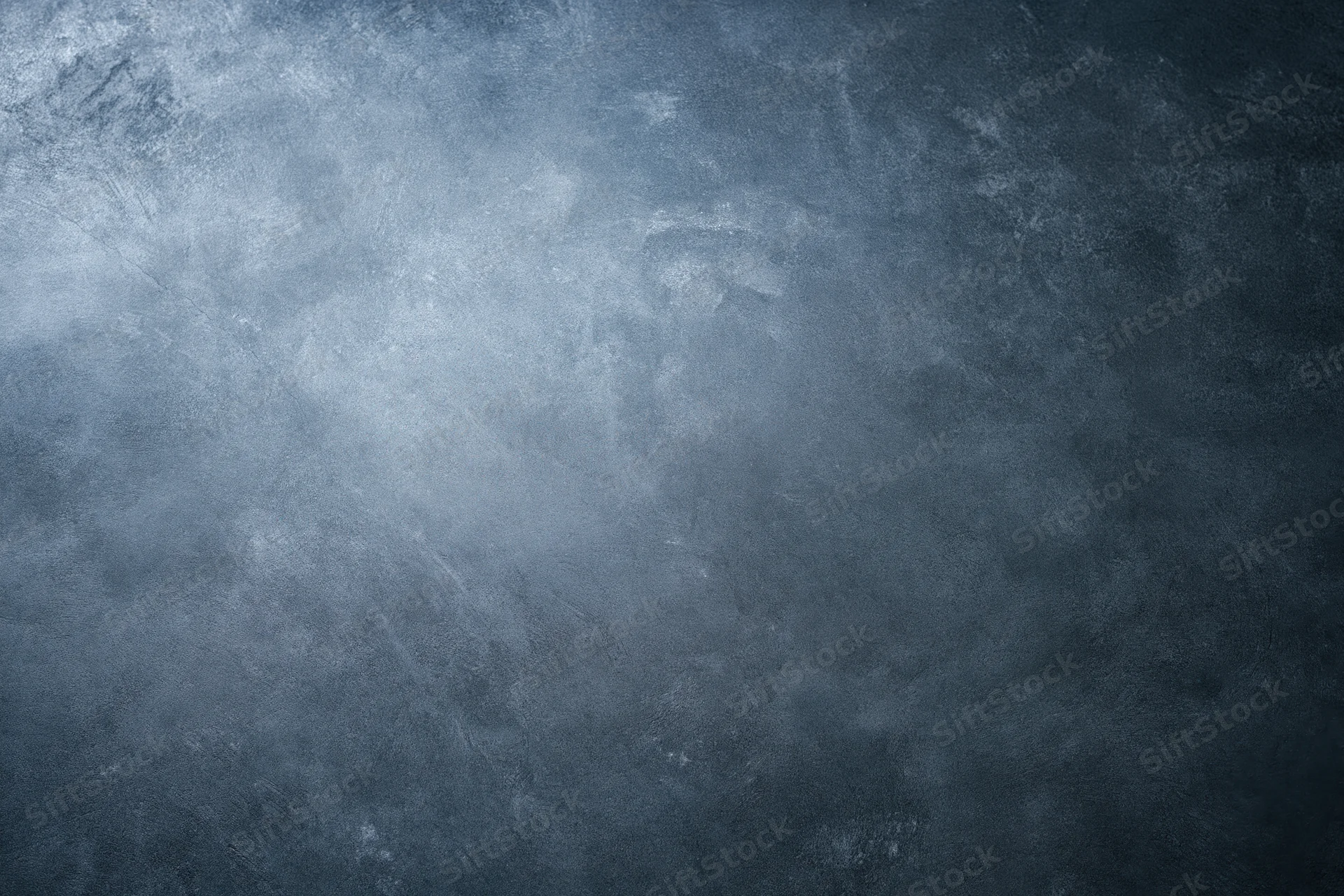 Close-up of a bare concrete wall surface with rough texture and gray-blue tones filling the frame