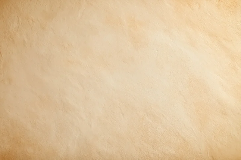 Close-up of a plain painted concrete wall surface with smooth texture and beige tone, used as background or copyspace