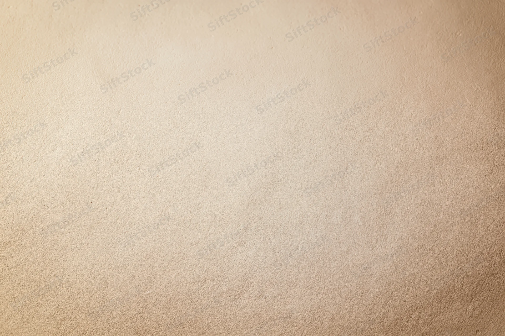 Close-up of a plain painted concrete wall surface with smooth texture and neutral beige tone