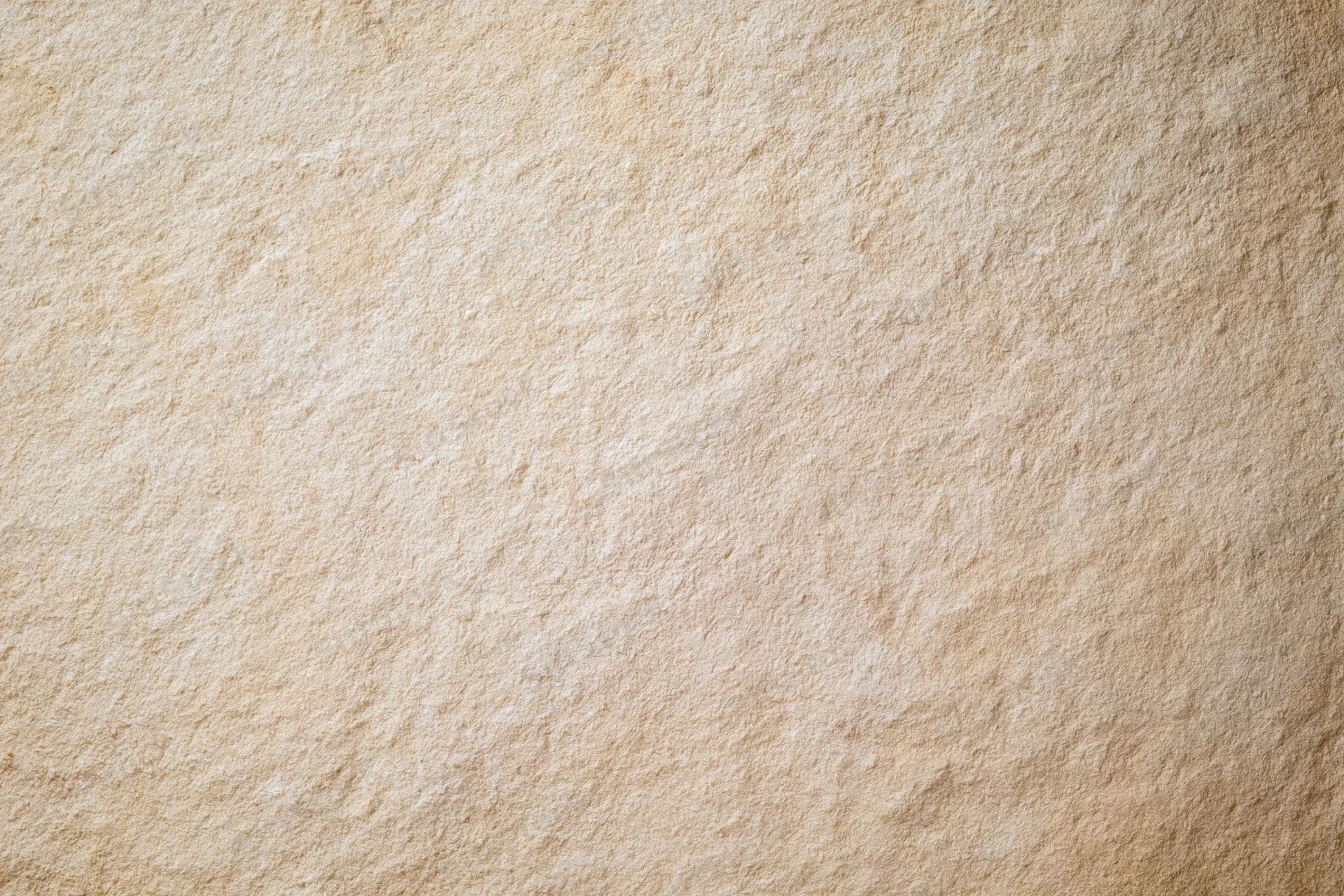 Close-up of a plain painted concrete wall surface with even texture and neutral beige tone