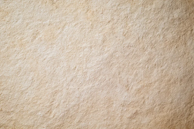 Close-up of a plain painted concrete wall surface with even texture and neutral beige tone
