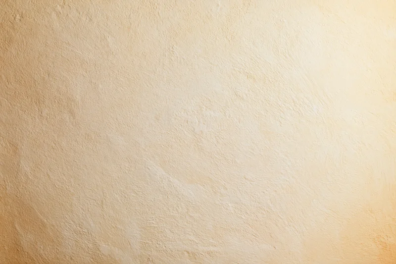 Close-up of a plain painted concrete wall surface with smooth texture and neutral beige tone