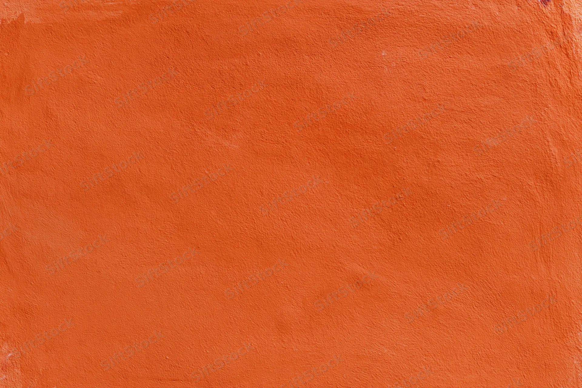 Close-up of an orange stucco plaster wall with textured surface and copyspace