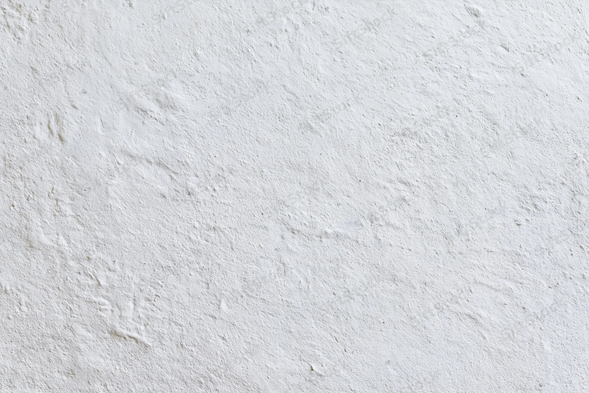 Close-up of a plain white plastered wall surface with textured finish