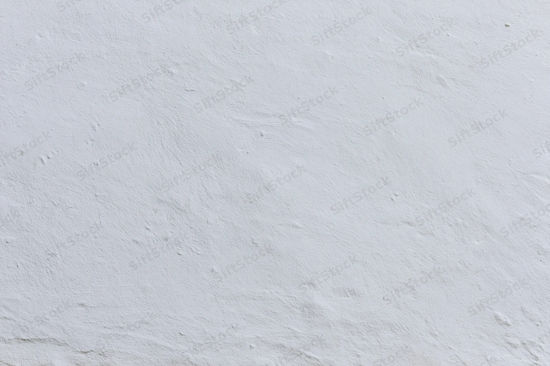 Close-up of a plain white plaster wall with subtle texture and even lighting