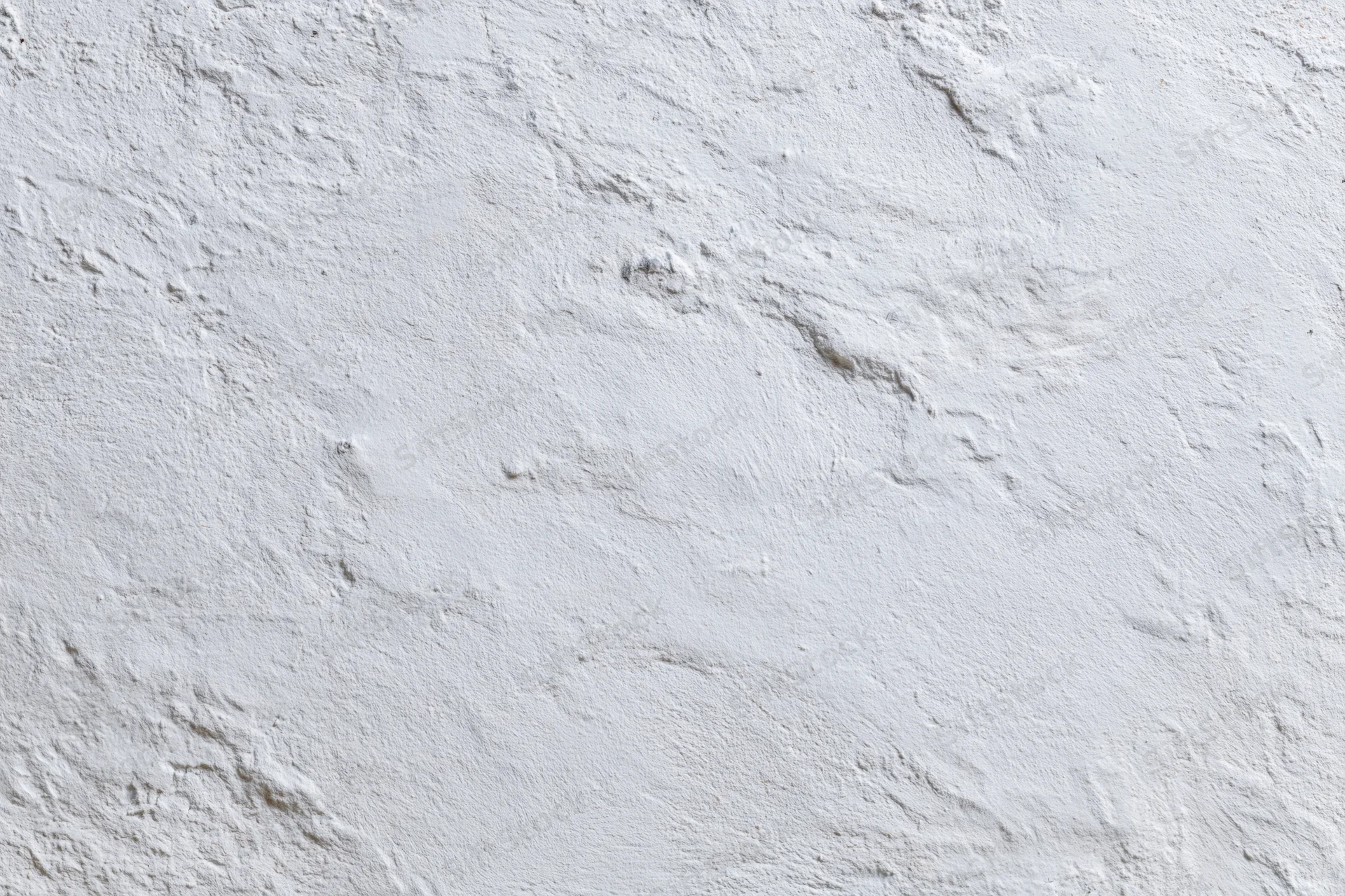 Close-up of a plain white plastered wall with rough texture