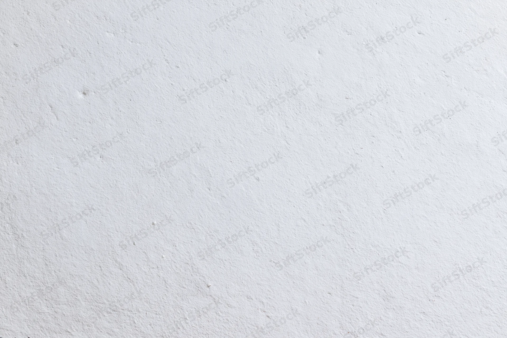 Close-up of a plain white plaster wall with subtle texture