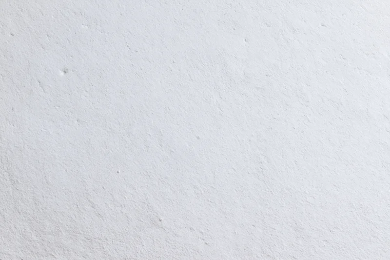 Close-up of a plain white plaster wall with subtle texture