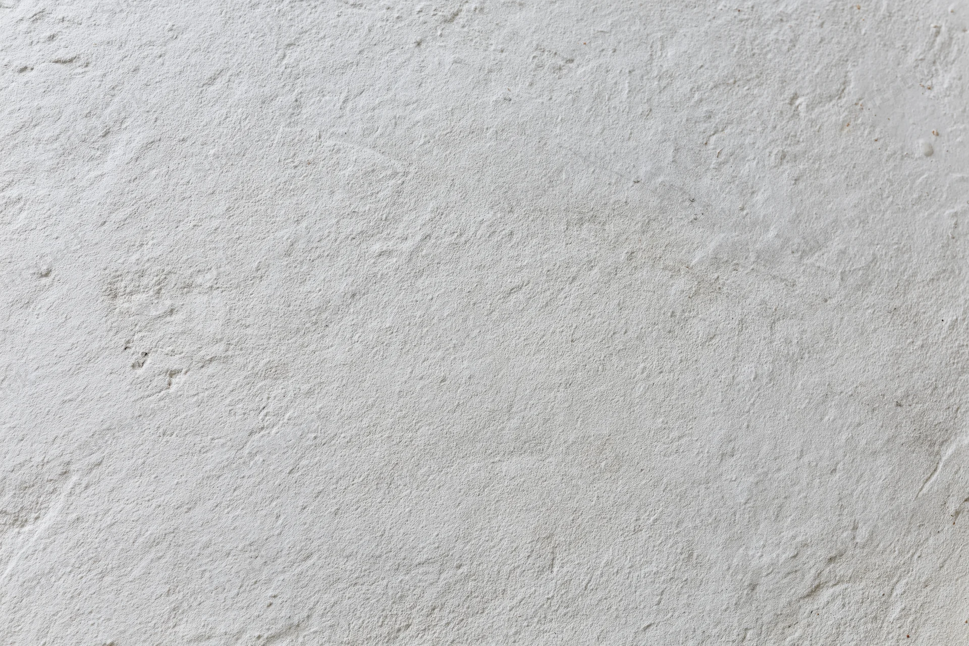 Close-up of a plain white painted concrete wall surface