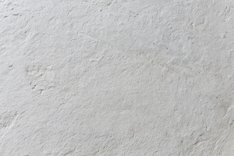 Close-up of a plain white painted concrete wall surface