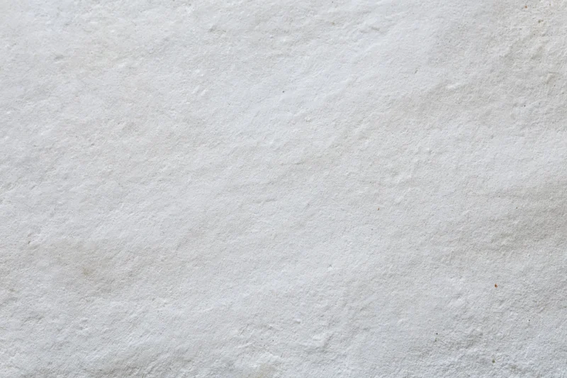 Close-up of a plain white painted concrete wall surface
