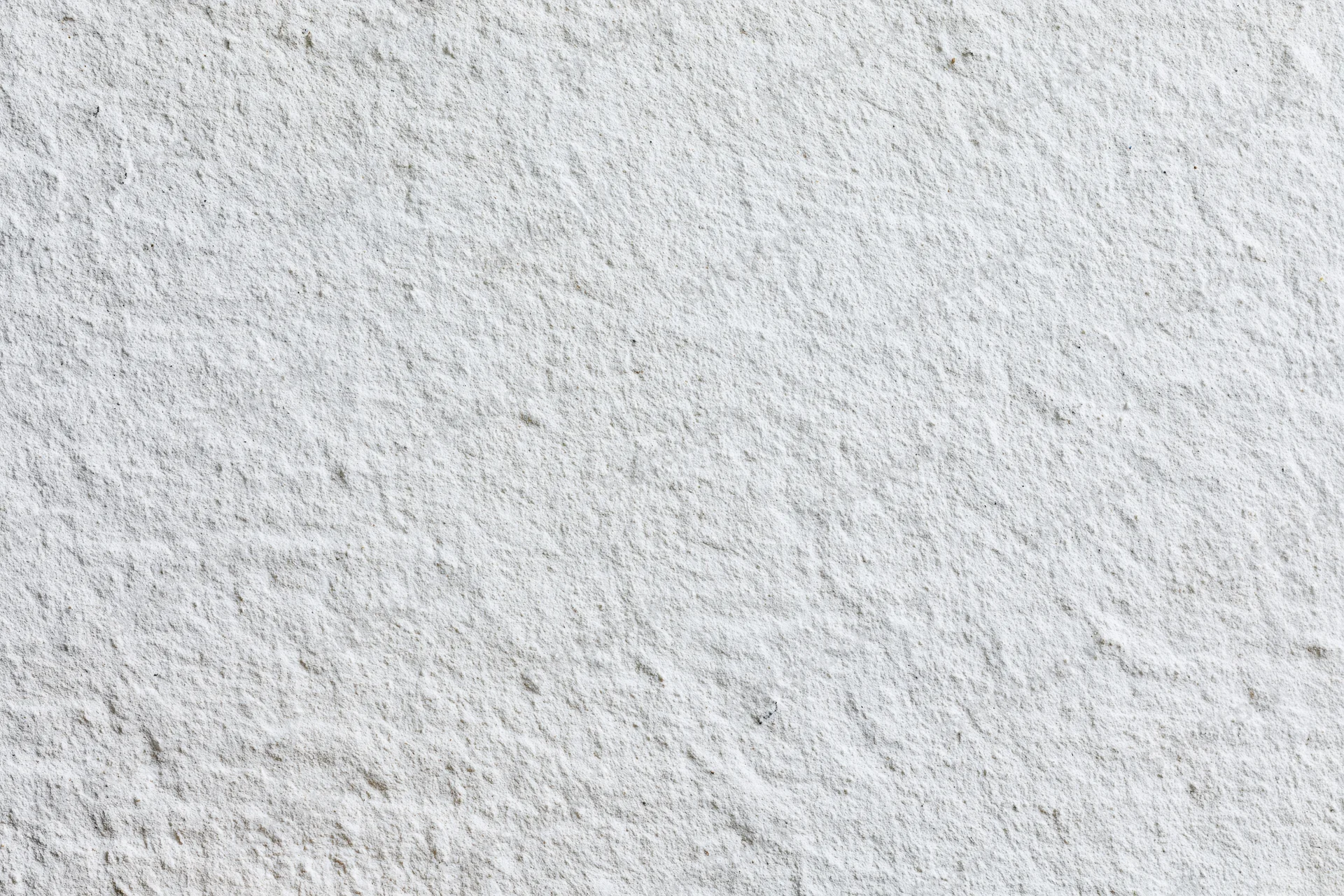 Close-up of a plain white painted concrete wall surface