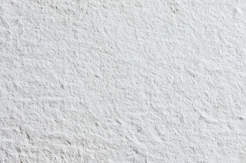 Close-up of a plain white painted concrete wall surface