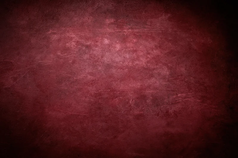 Close-up of an aged red concrete wall surface with textured grunge finish