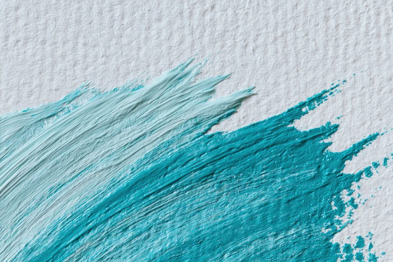 Thick acrylic paint brushstrokes on textured white paper