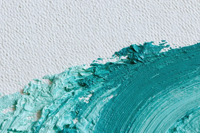 Thick acrylic paint brushstrokes on textured white paper