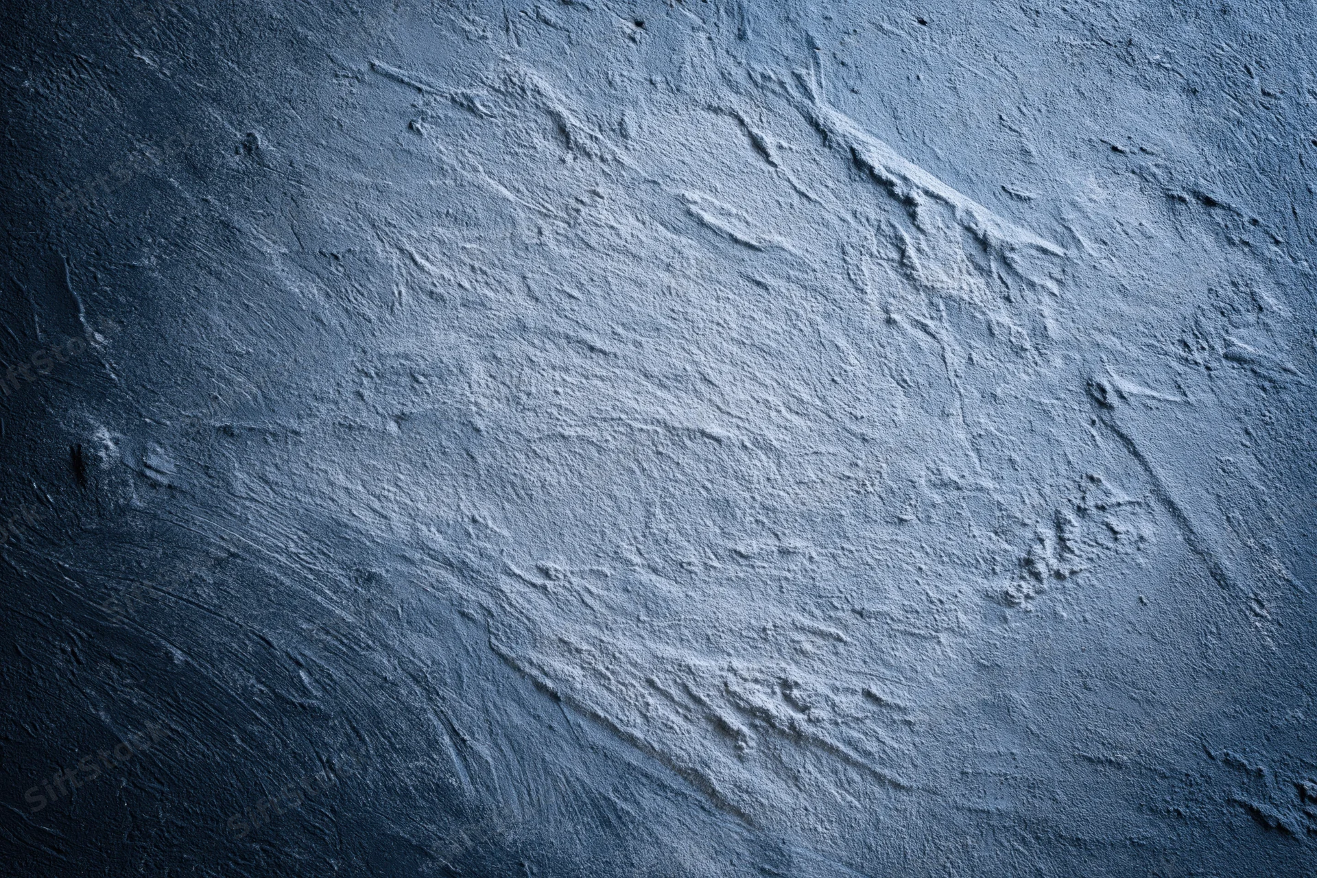 Weathered concrete wall surface with rough texture and visible cracks filling the frame