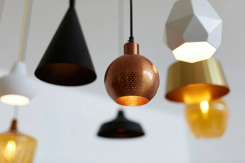 Modern pendant lamps hanging at varying heights in a minimalist interior