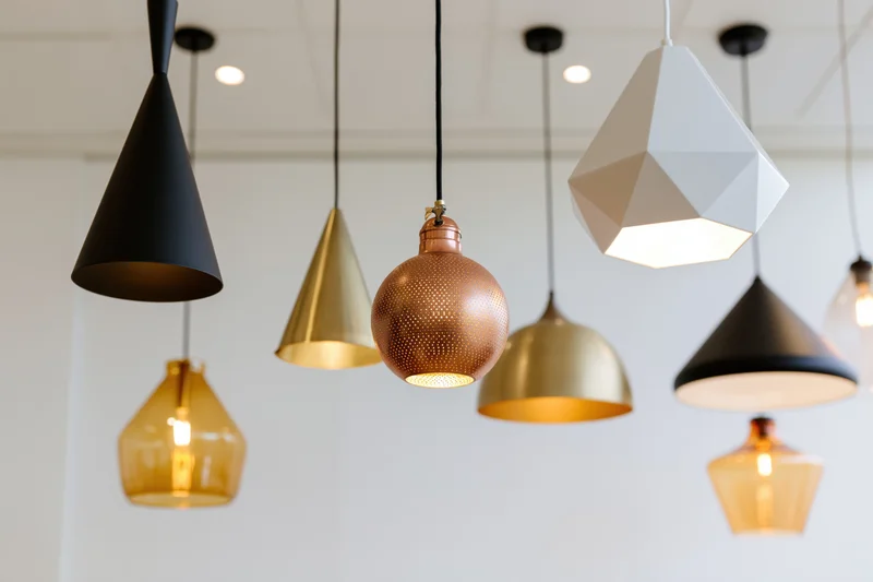 Modern pendant lamps hanging at varying heights in a bright interior space