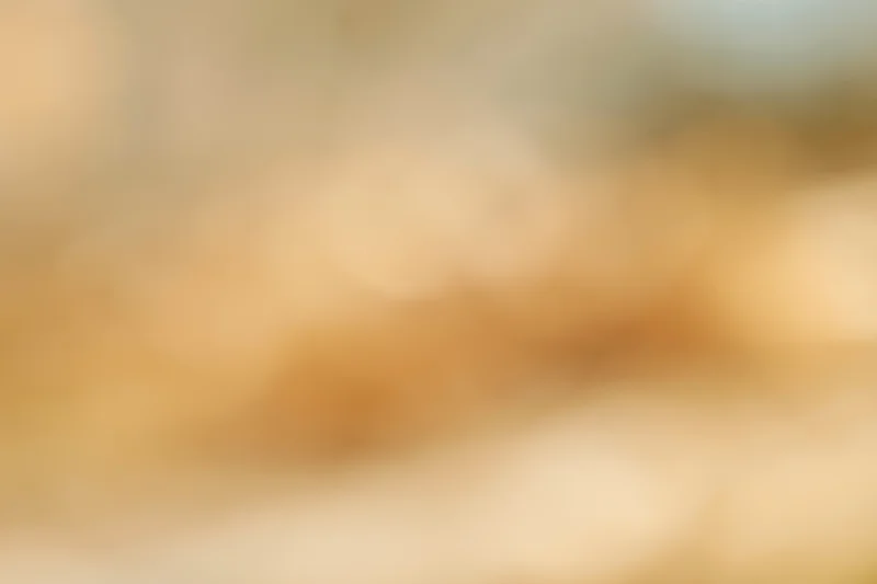 Abstract blurred background with warm golden bokeh lights and soft glow