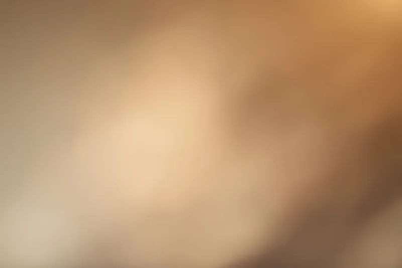 Warm-toned blurred abstract background with soft gradient and bokeh effect
