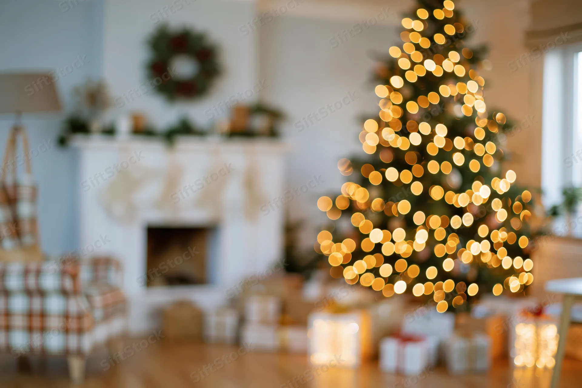 Christmas tree with glowing lights and decorations in a cozy living room with fireplace and gifts