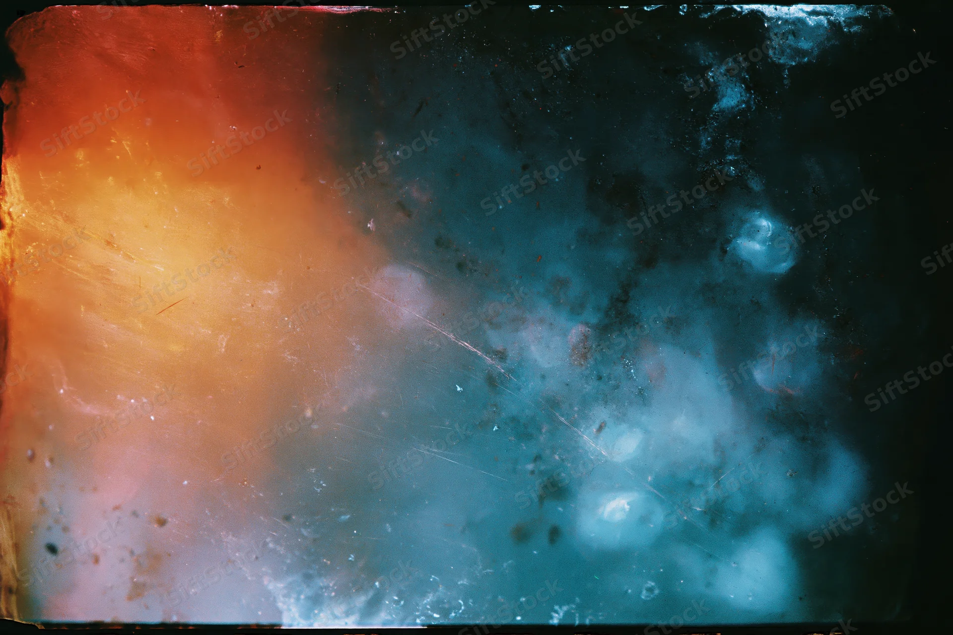 Damaged 35mm film frame showing heavy light leaks and lens flare with orange and blue color gradients
