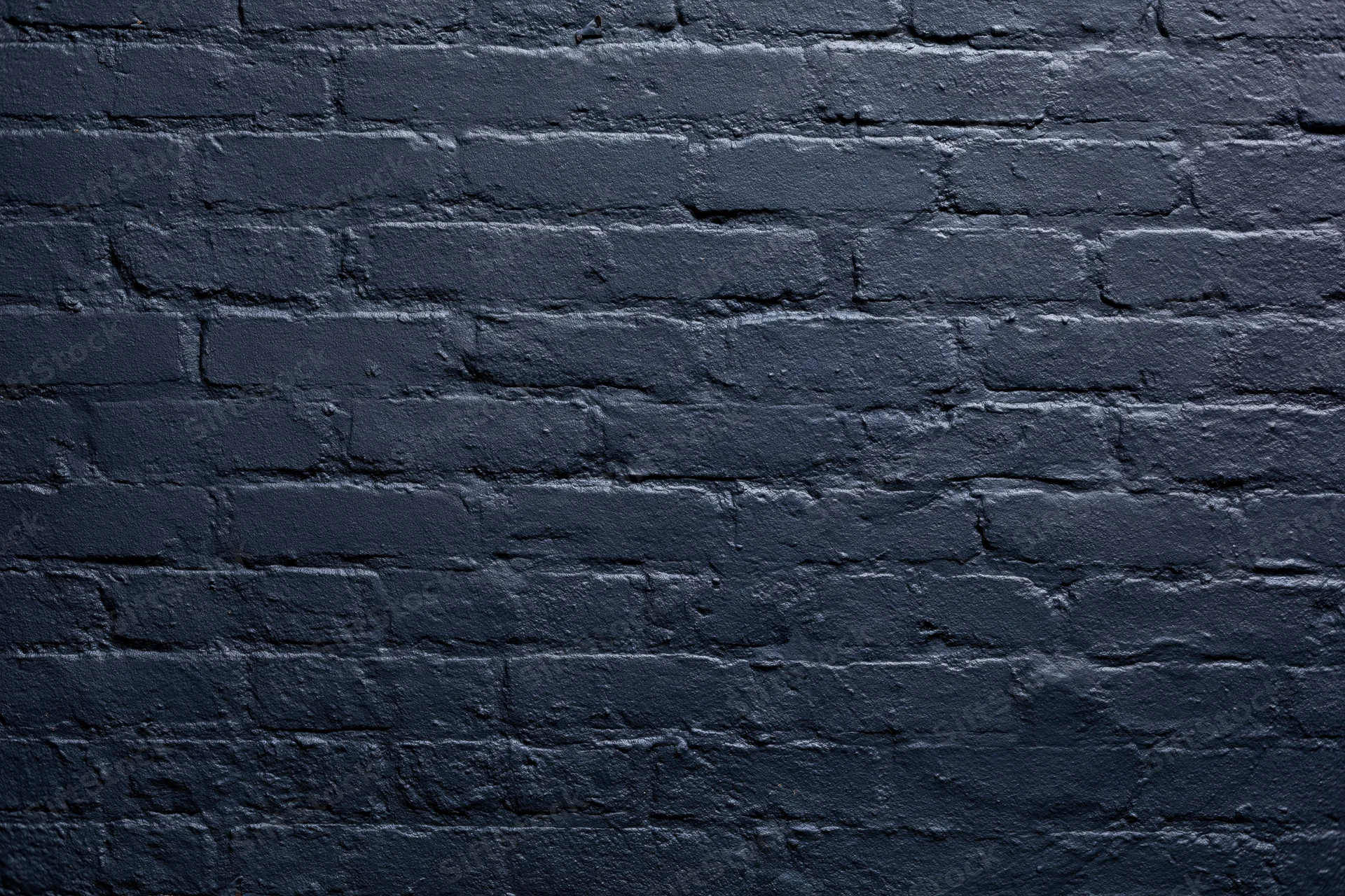 Navy-painted brick wall filling the frame flat-on