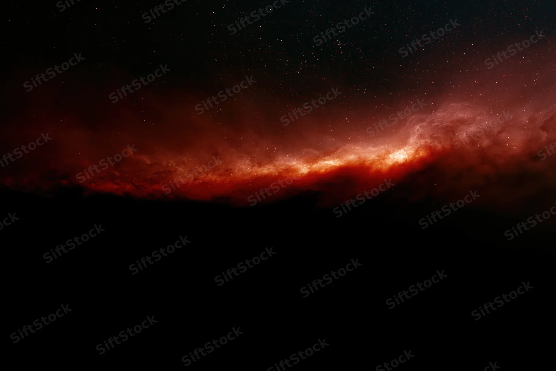 Diagonal red nebula glowing in dark space with scattered stars