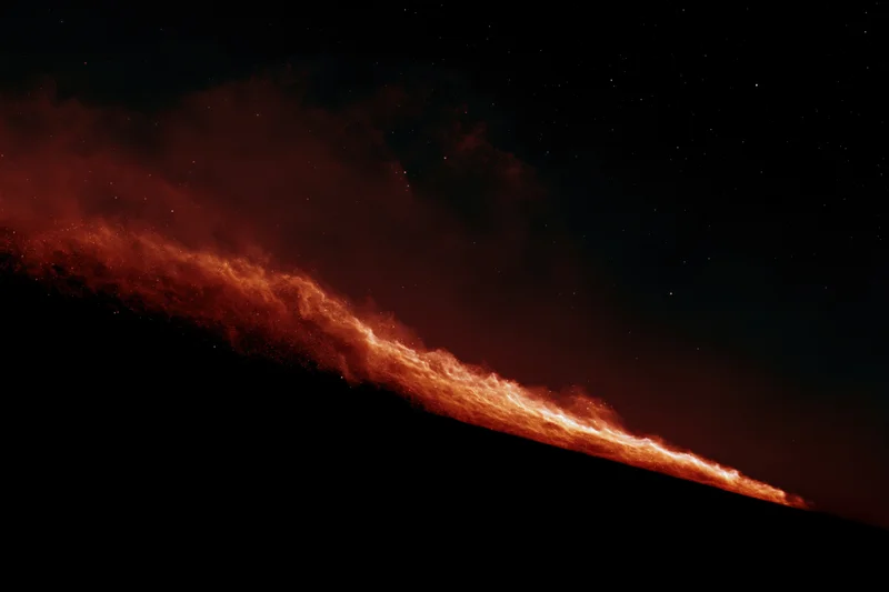 Diagonal streak of glowing red nebula across dark space with scattered stars