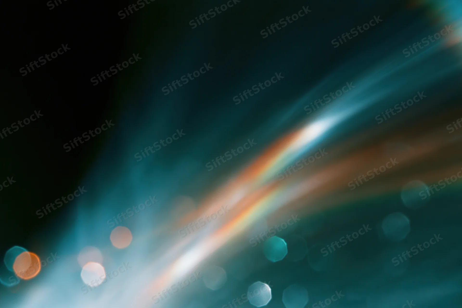 Defocused light streaks and bokeh circles against a dark gradient background