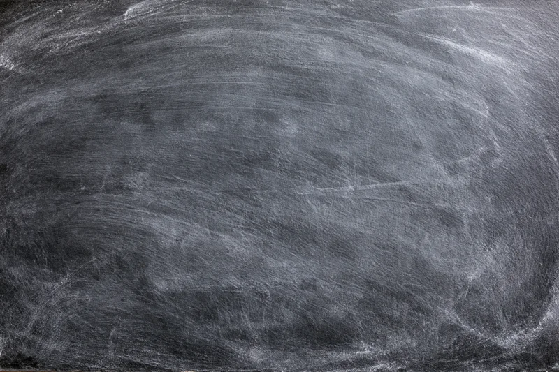 Close-up of empty blackboard surface with chalk residue filling the frame