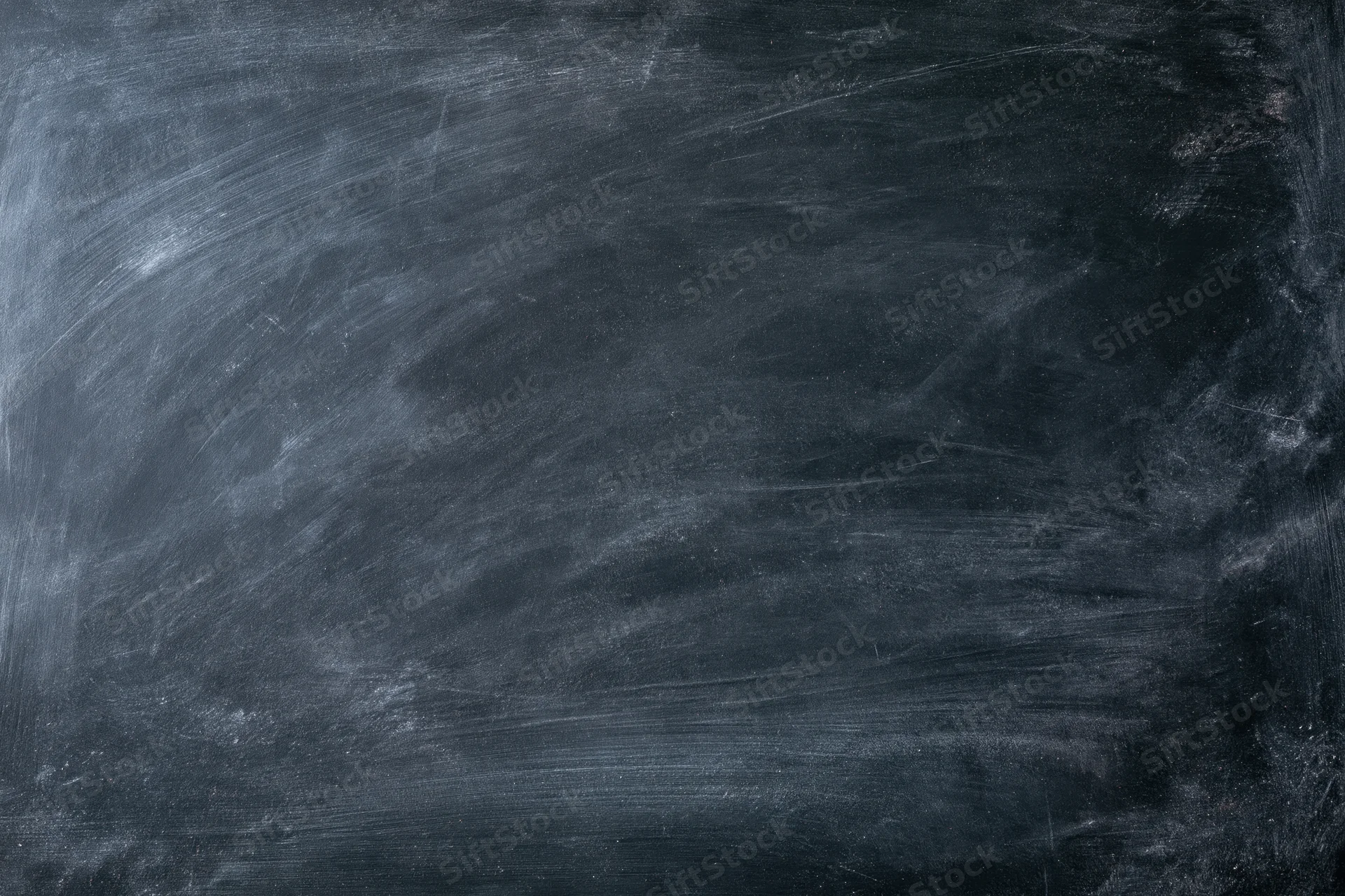Empty blackboard surface filling the frame with chalk residue and smudges