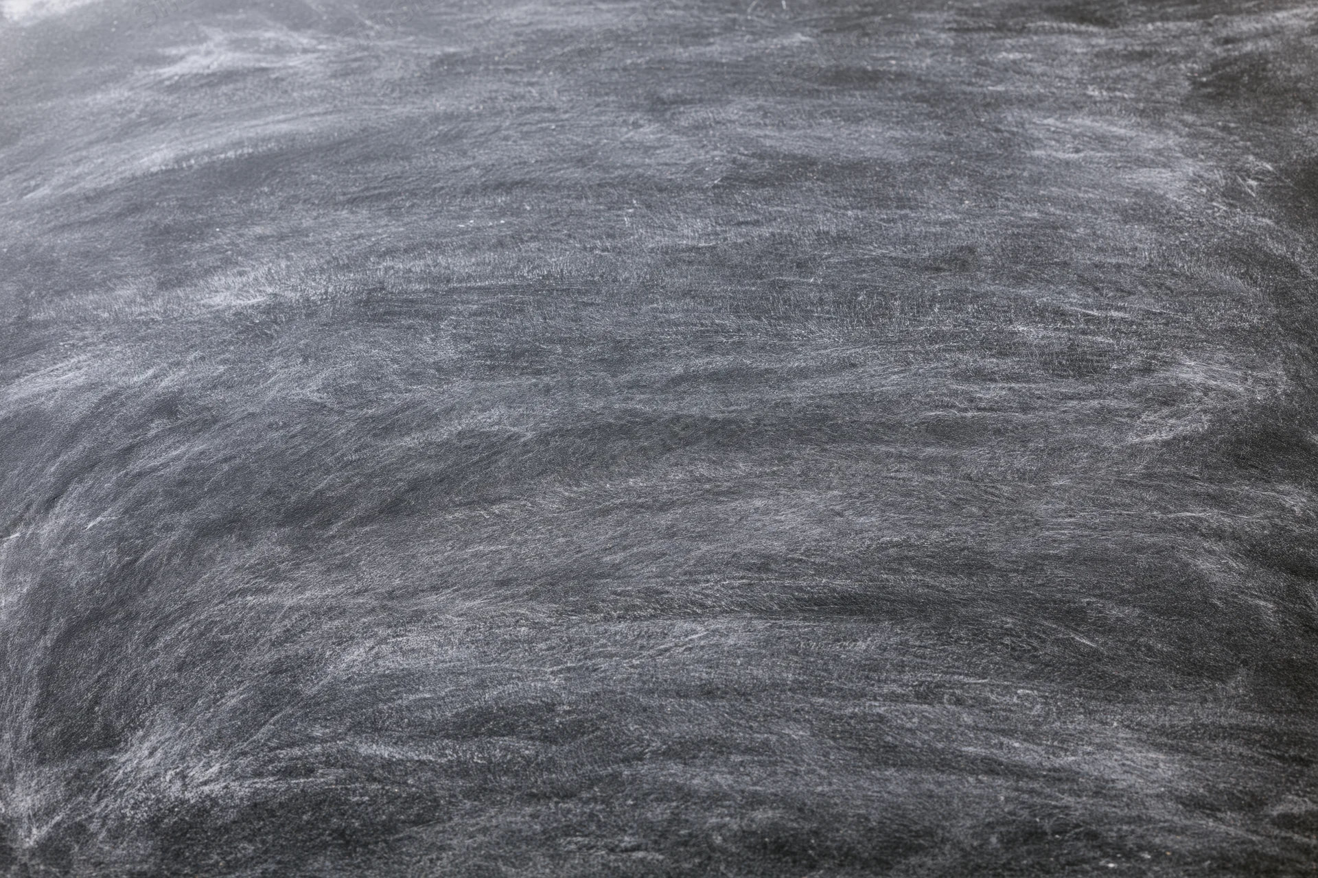 Close-up of empty blackboard surface with chalk residue filling the frame