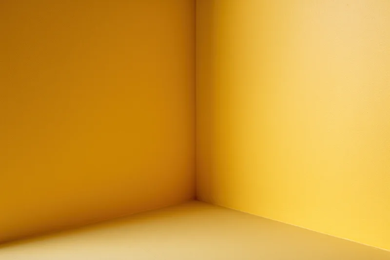 Empty corner of a room with golden yellow walls and floor
