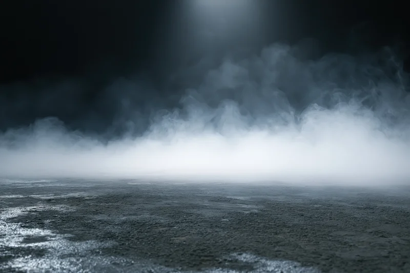 Dense white smoke rising over dark concrete floor in empty industrial space