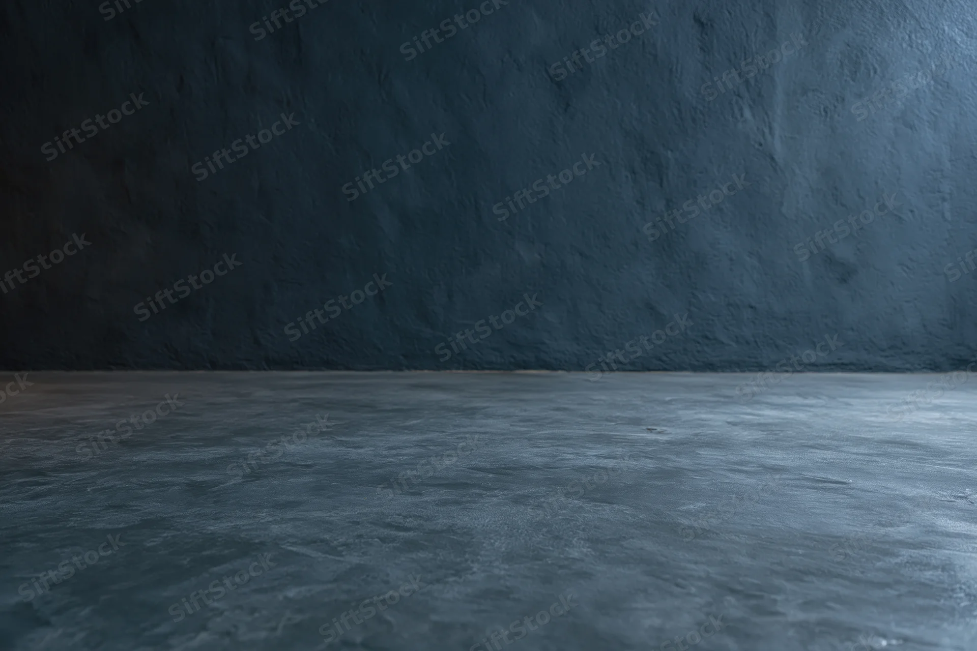 Empty dark concrete room interior with textured wall meeting floor