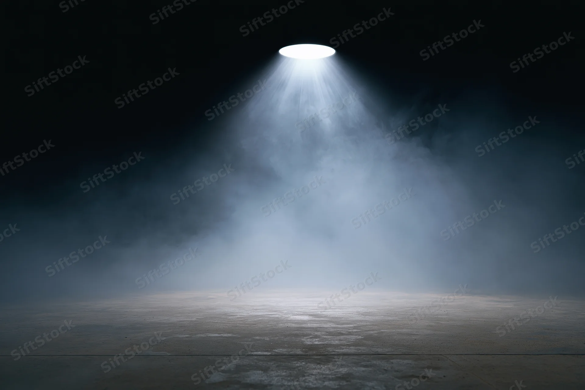Empty dark stage illuminated by a single overhead spotlight with fog on the floor