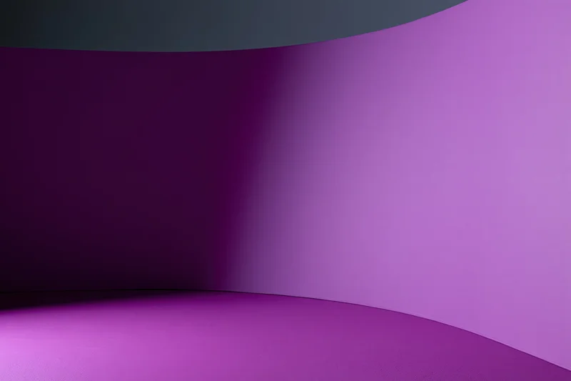 Seamless curved purple backdrop in empty photography studio interior