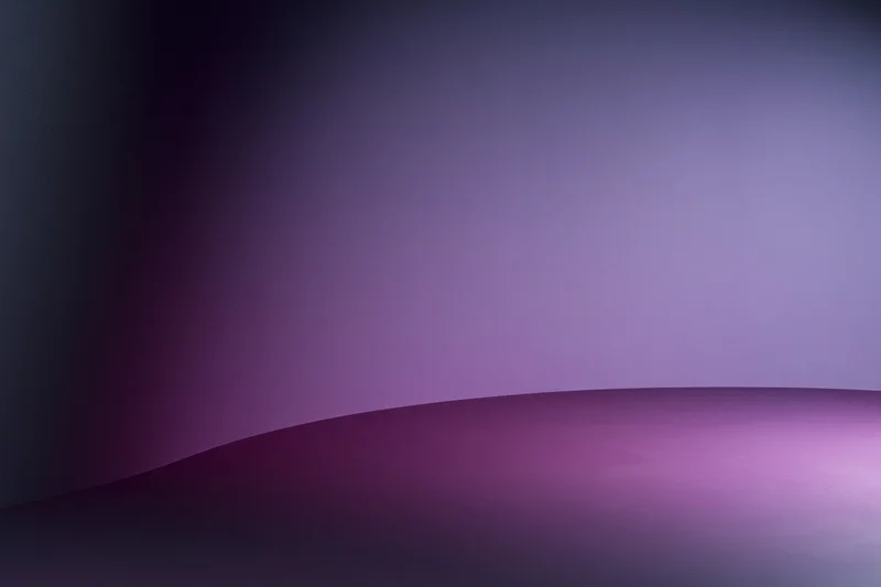 Seamless curved purple gradient backdrop in a photography studio