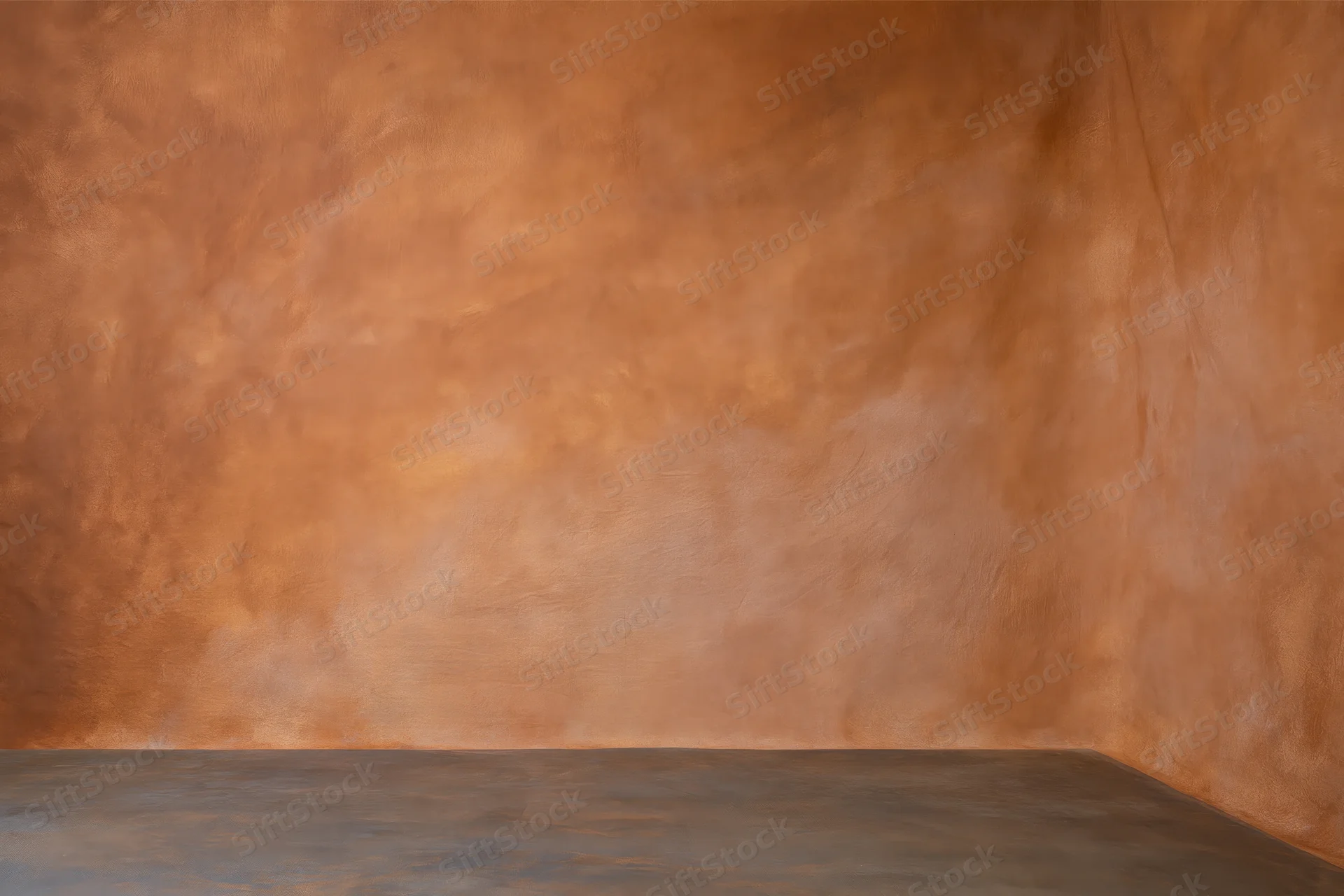 Empty studio backdrop with warm hand-painted muslin wall and concrete floor