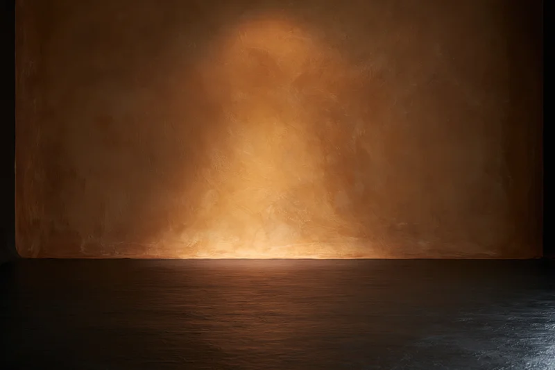 Textured painted canvas wall illuminated by spotlight in empty studio space