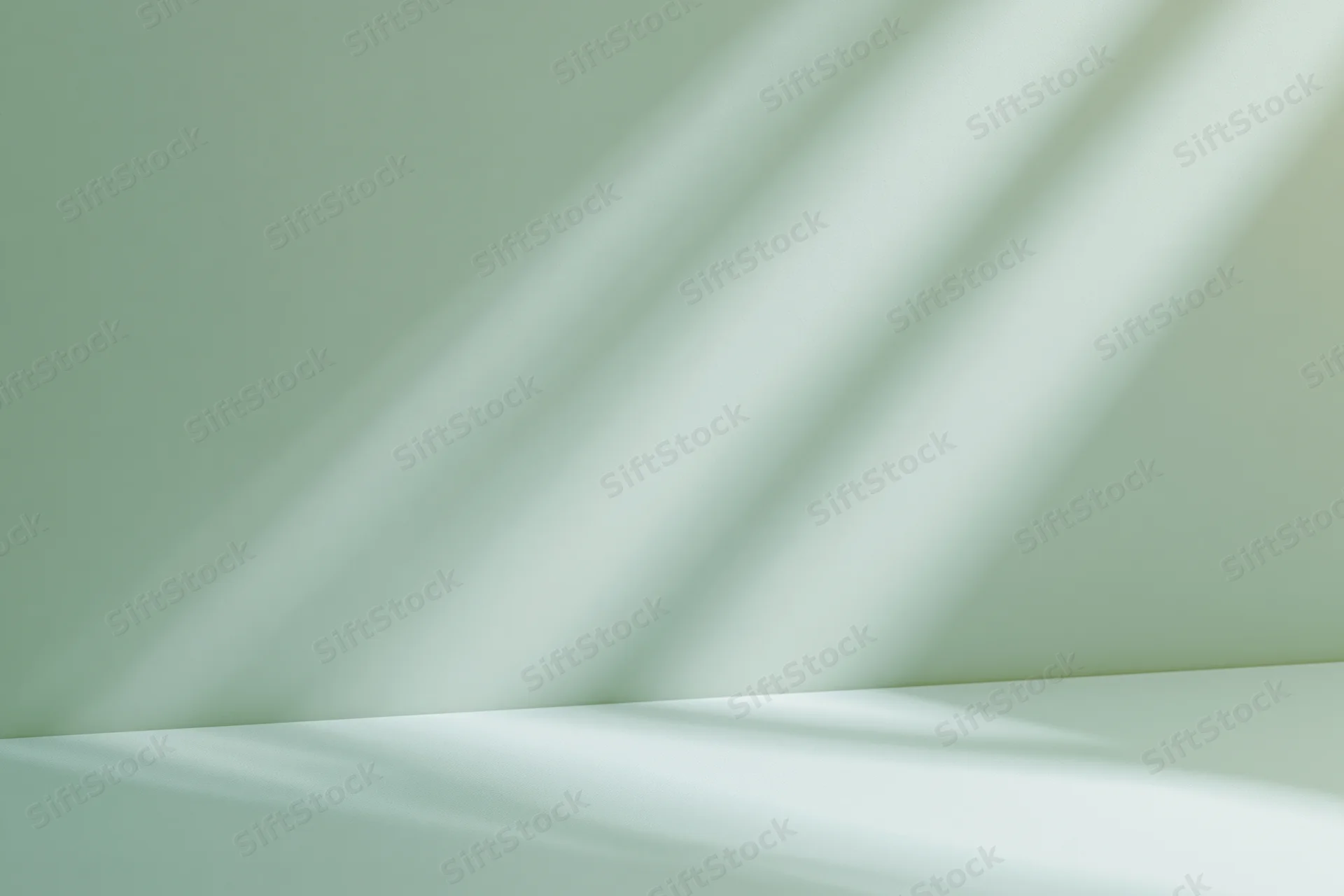Seamless sage green studio backdrop with diagonal light shadows on wall and floor