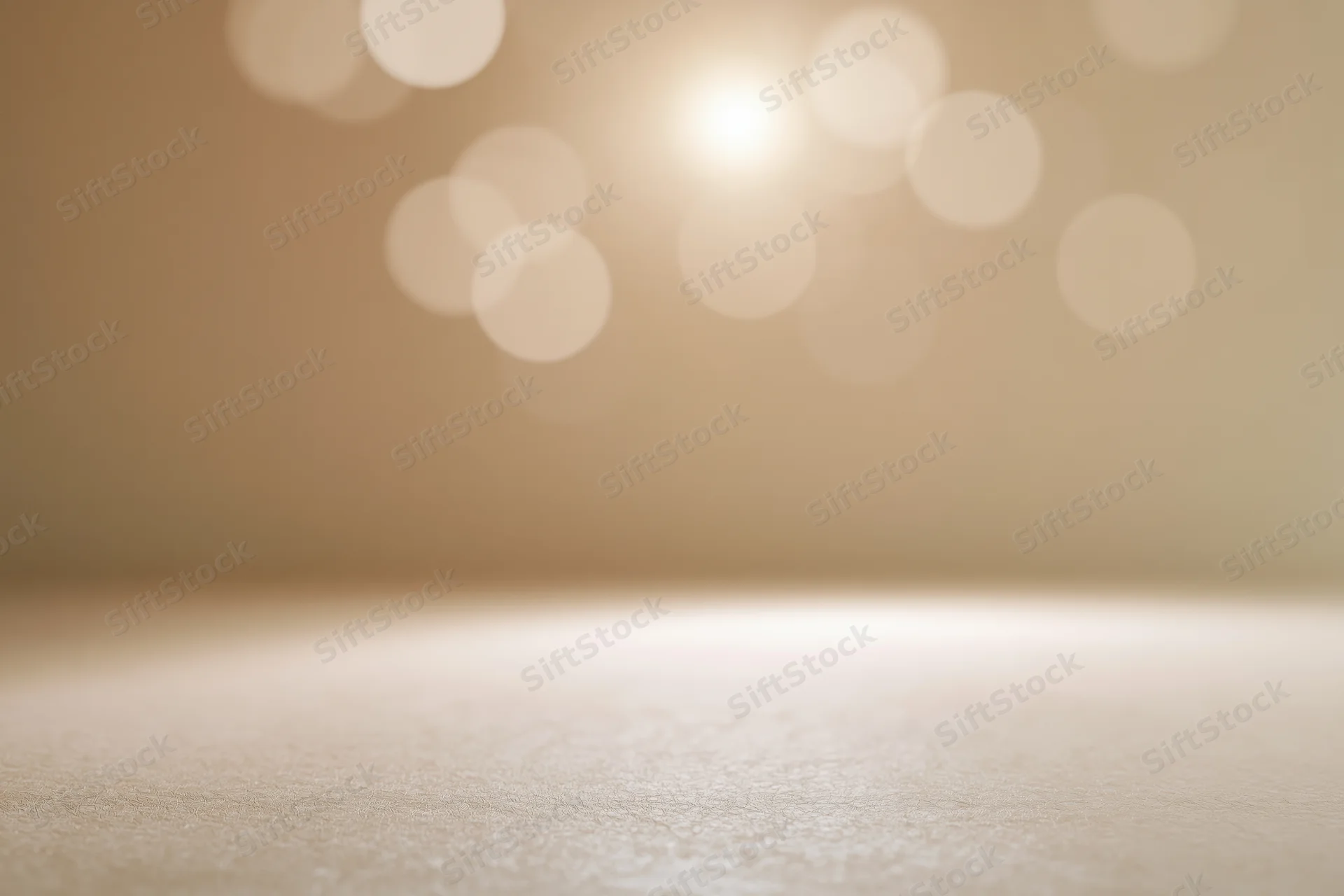 Empty studio backdrop with soft golden bokeh lighting and copyspace for product display