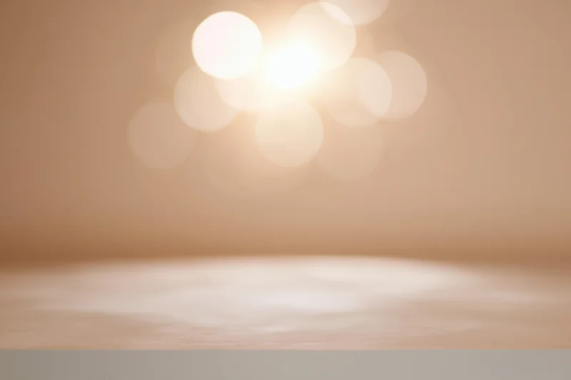 Empty wooden table with soft bokeh backlight in studio backdrop