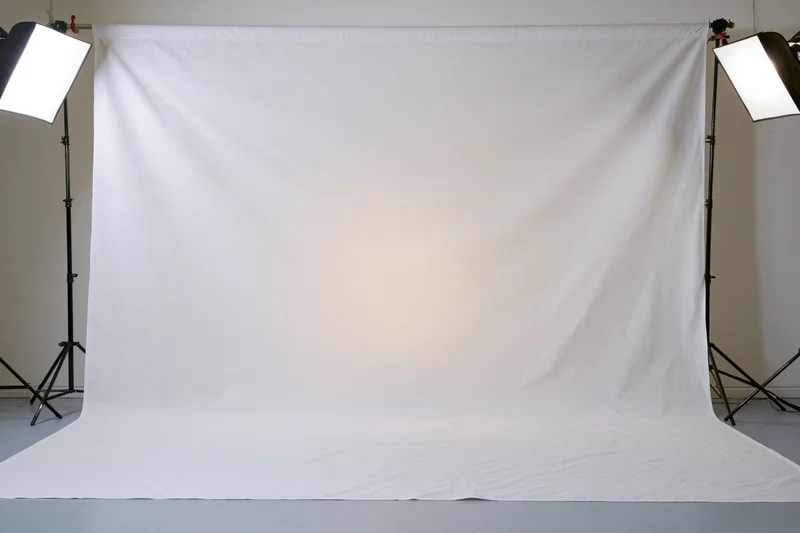 Seamless white fabric backdrop lit by softboxes in a photography studio