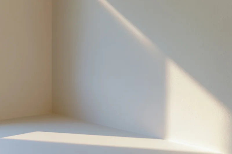 White studio corner with light and shadow on smooth walls and floor